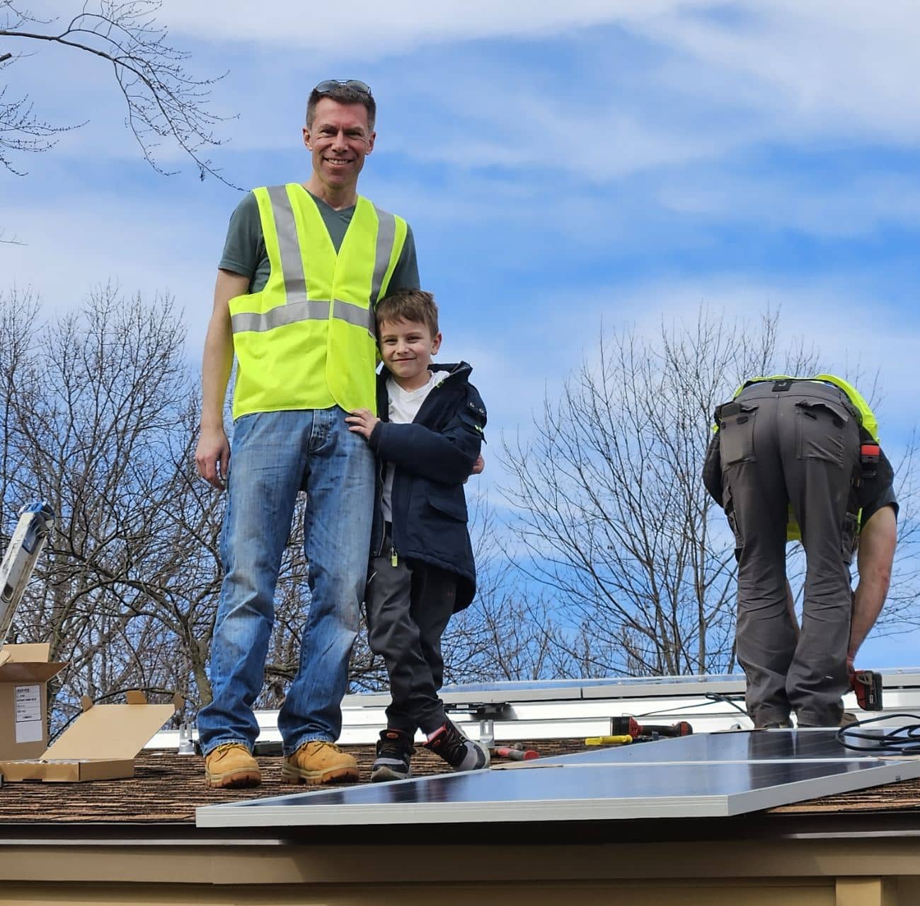 Daniel and Noah on a roof during a panel installation